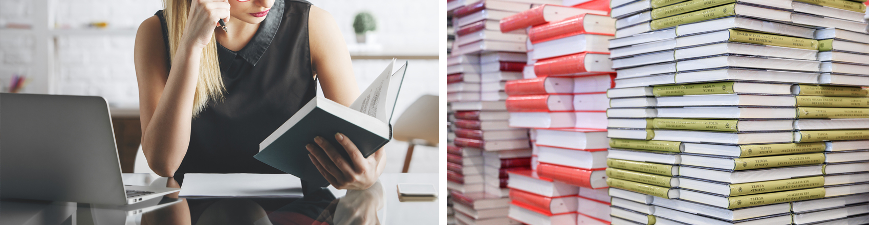 Frau am Schreibtisch hält Buch in der Hand - daneben Bücherstapel